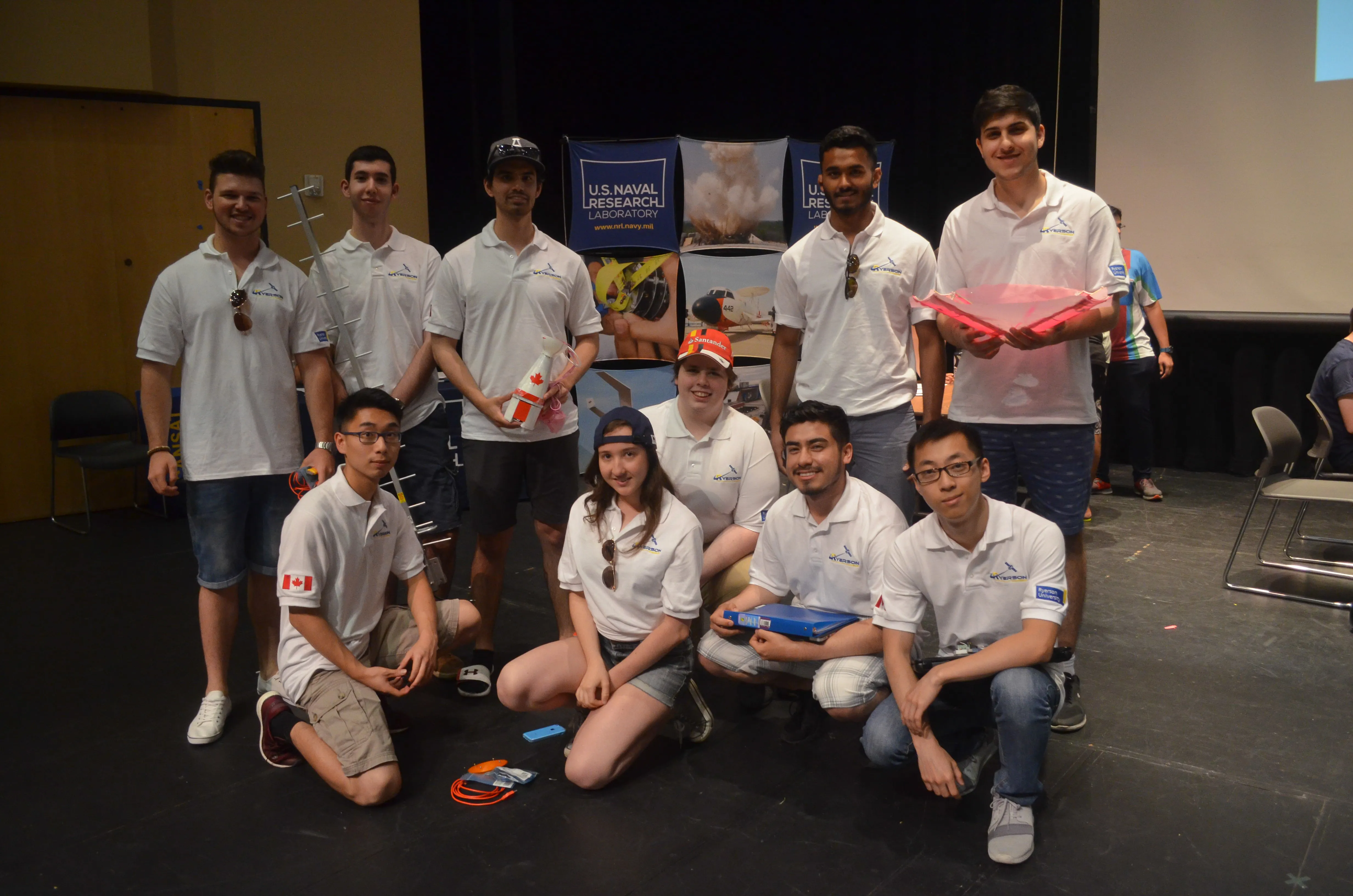 CanSat team members presenting their satellite hardware at a competition